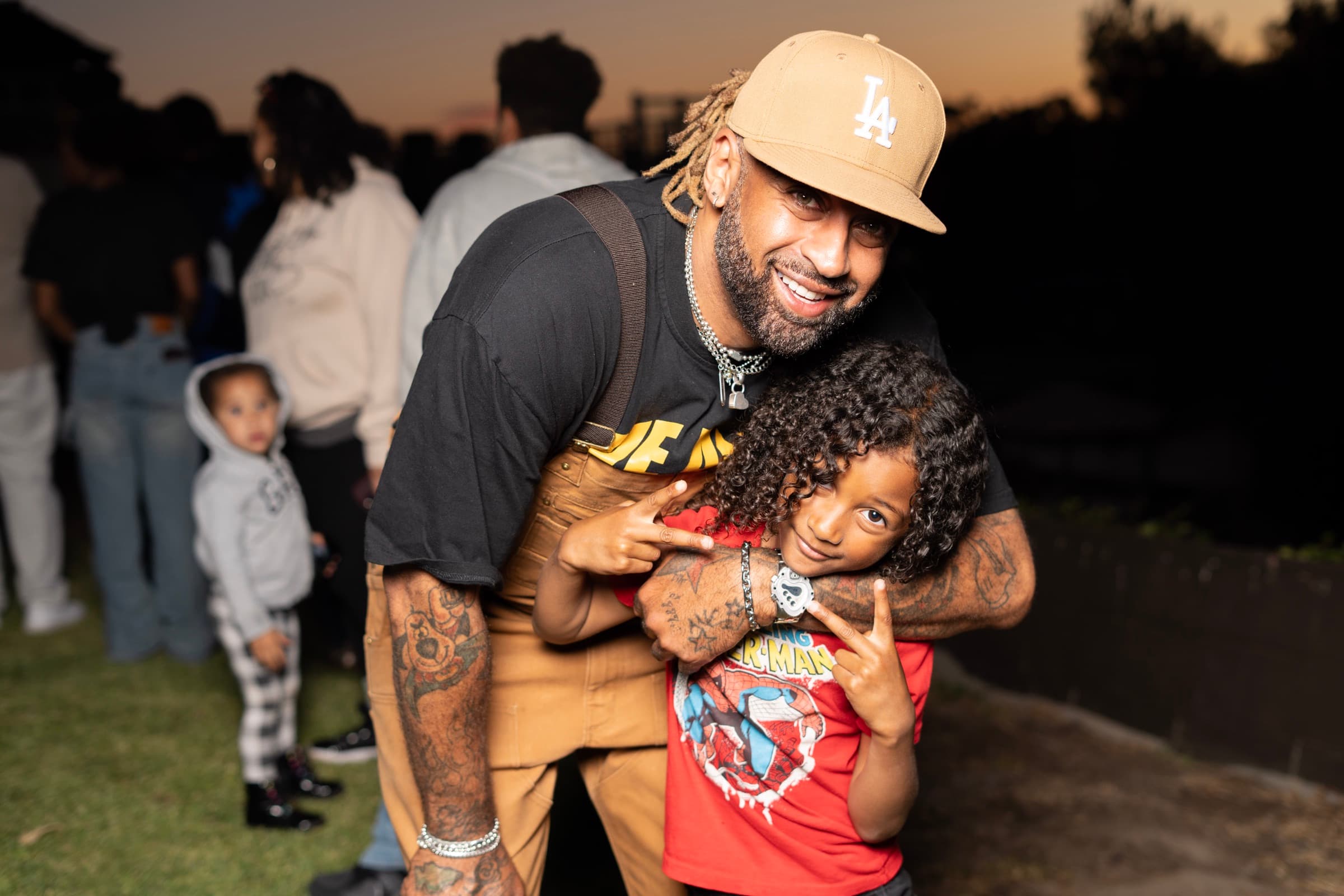 A father and child posing together at an outdoor event